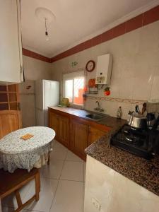 a kitchen with a sink and a counter top at Casa Amina in Martil