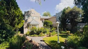 a house with a garden in front of it at Patcham Place, Clarens in Clarens