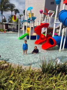 two people in the water at a playground at GAV Beach Resort - Smart in Salinópolis