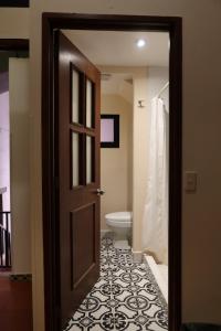 a door leading to a bathroom with a toilet at Escondite de Galarza 26 in Guanajuato +38 photos