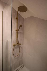 a shower with a shower head in a bathroom at Almara stone house - Authentic stone house in Vis in Vis