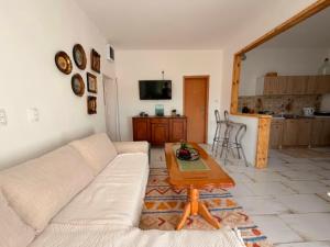 a living room with a couch and a table at Water Lily Dock Prevlaka in Prevlaka
