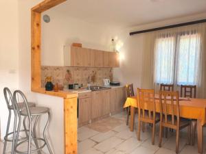 a kitchen and dining room with a table and chairs at Water Lily Dock Prevlaka in Prevlaka