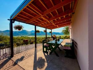 a patio with a table and a view of the mountains at Water Lily Dock Prevlaka in Prevlaka