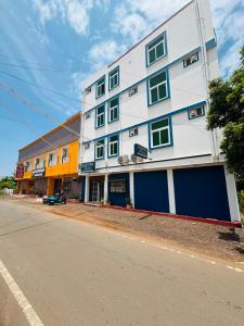 a building on the side of a street at Aquora Pool Stays in Pondicherry