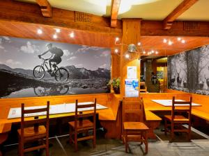 a restaurant with a large picture of a man on a bike on a wall at Indren Hus in Alagna Valsesia