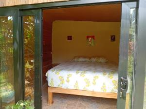 a bed in a glass door with a bed inside at Island Breeze in Negril