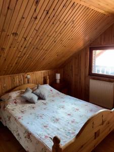 a bedroom with a bed in a wooden cabin at Brvnara Nenadić in Užice