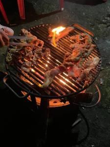 a grill with some meat on top of it at Prathmesh Homestay in Bijanbāri Bāzār