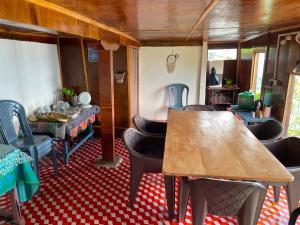 a dining room with chairs and a wooden table at Prathmesh Homestay in Bijanbāri Bāzār