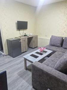 a living room with a couch and a table at Zvartnoc siti star in Pʼarakʼar