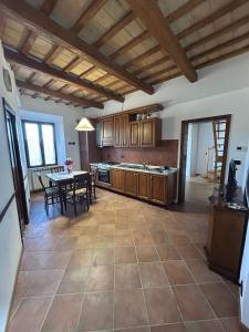 a kitchen with a table and a dining room at Sibillini Dream House in Amandola