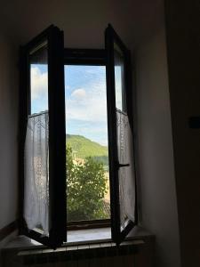 an open window with a view of a tree at Sibillini Dream House in Amandola