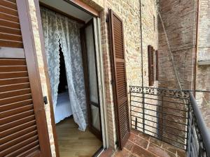 a door leading to a balcony with a bed at Sibillini Dream House in Amandola
