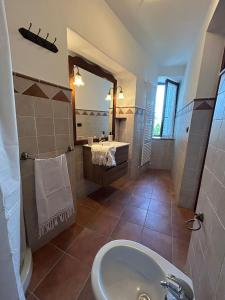 a bathroom with a sink and a toilet and a mirror at Sibillini Dream House in Amandola +26 photos