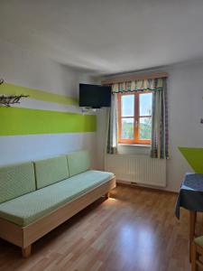 a living room with a couch and a window at Reitpark Gstöttner in Schönau im Mühlkreis