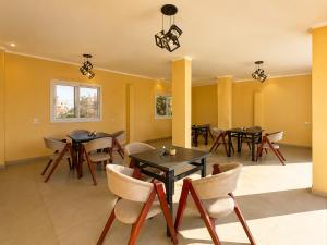 a dining room with tables and chairs at Saqqara Pyramids view Hotel in Cairo