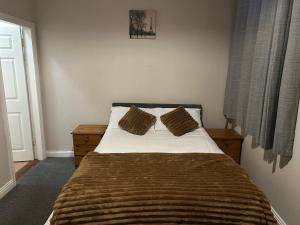a bedroom with a bed with two pillows on it at The pillar in Wexford