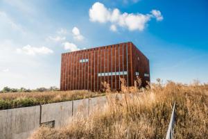 a brown building in the middle of a field at Kestanbol Hotel in Çanakkale +19 photos