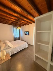 a bedroom with a bed and a book shelf at mare Mali Tinos in Mamádhos