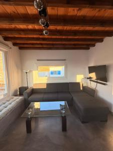 a living room with a couch and a table at mare Mali Tinos in Mamádhos