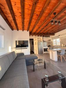 a living room with a couch and a table at mare Mali Tinos in Mamádhos +7 photos