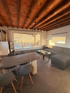 a living room with a couch and a table at mare Mali Tinos in Mamádhos
