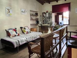 a bed in a room with a table and chairs at Casa Medieval de Nisa in Nisa
