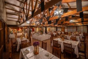 a dining room with white tables and chairs at Hotel San Agustin Urubamba in Urubamba