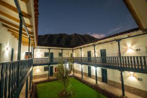 an exterior view of a building with a courtyard at Hotel San Agustin Urubamba in Urubamba