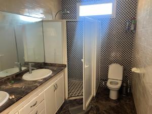 a bathroom with a toilet and a sink and a shower at Villa Tamaris, Dar Bouazza in Tamaris +9 photos