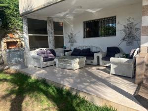 a patio with couches and a coffee table on it at Villa Tamaris, Dar Bouazza in Tamaris