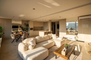 a living room with a white couch and a table at Penthouse Centrum Nitra Jacuzzi&View, free parking in Nitra
