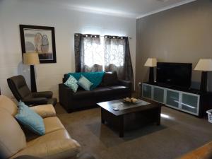 a living room with a couch and a coffee table at Mapperley Bed and Breakfast in Bordertown