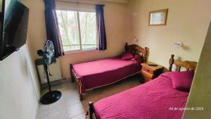 a bedroom with two beds and a window at Ayalata del Rio in Colón