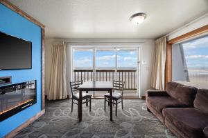 a living room with a table and a couch at Surfside Resort in Rockaway Beach
