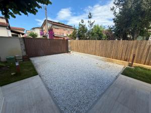 a backyard with a fence and a gravel yard at Casa Arianna in Lido di Camaiore