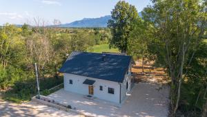an overhead view of a white house with a blue roof at Holiday Home Ari in Lički Ribnik
