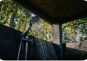 a shower with water coming out of it at Sora Bell Tent in Coxwold +7 photos