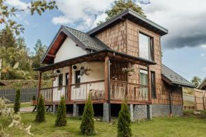 a tiny house with a wrap around porch at Villa Pelahia in Slavske