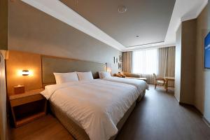 a bedroom with a large white bed in a room at Daegu Grand Hotel in Daegu +44 photos