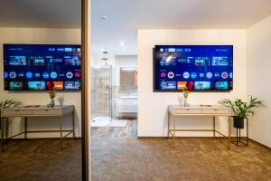 a room with two tables and a large screen on the wall at Penthouse Centrum Nitra Jacuzzi&View, free parking in Nitra
