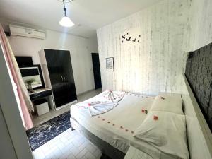 a small bedroom with a bed and a television at Delphin Hotel Side in Side +53 photos