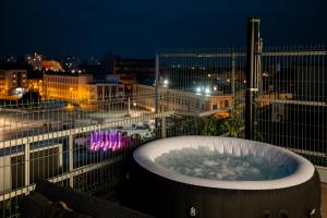 a hot tub on top of a balcony at night at Penthouse Centrum Nitra Jacuzzi&View, free parking in Nitra