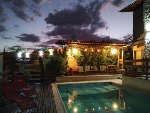 a swimming pool at night with a house at Talita Cumi in Villa Santa Cruz del Lago