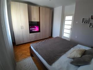 a bedroom with a bed and a tv in it at Bulevar in Šabac