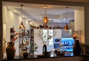 a kitchen with a counter with vases on it at L'Appartement La Roche Élégance et confort in Banzart