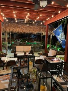 a patio with tables and chairs and a flag at Blue Gem in Key West
