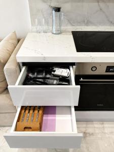 an open drawer in a living room with a couch at Sea Breeze Apartments in Baku