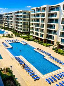 an overhead view of a swimming pool with chairs and umbrellas at Sea Breeze Apartments in Baku